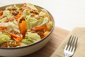Delicious salad with Chinese cabbage and mustard seed dressing on white wooden table, closeup