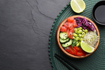 Delicious poke bowl with vegetables, fish and edamame beans on black table, flat lay. Space for text