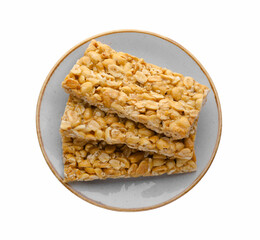 Plate with tasty peanut bars (kozinaki) isolated on white, top view