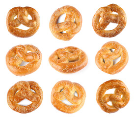 Set with tasty freshly baked pretzels on white background