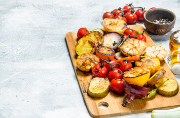 Grilled vegetables with spices and herbs on a cutting Board.