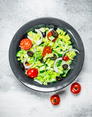Vegetable salad. Salad of cucumbers, tomatoes and red onions with spices and olive oil.