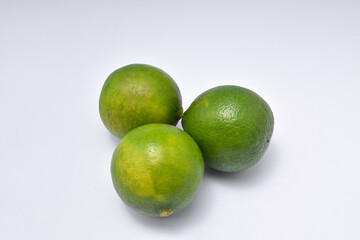 three limes isolated on a white background.