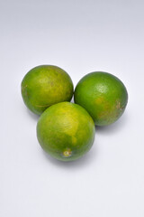 three limes isolated on a white background.