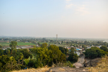 Landscape view with rocks formation, houses and trees