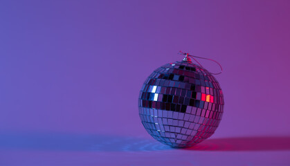 Disco ball in neon lighting isolated, concept of party, disco and dancing, copy space.