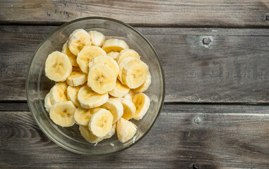 Banana slices in a glass bowl.