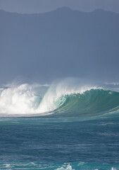 Big breaking Ocean wave on a sandy beach on the north shore of Oahu Hawaii