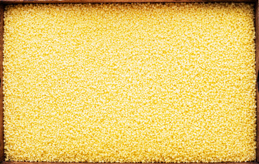 Fototapeta premium Couscous, dry wheat grain, food background texture, top view