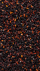 Wild raw black rice groats, food background texture, top view vertical banner