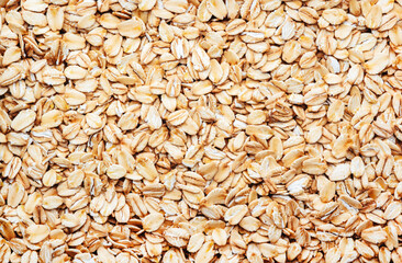 Raw organic oatmeal, food background texture, top view