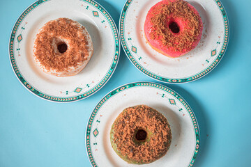 Homemade donuts with the basic ingredients of palm sugar in a flat lay photo served on a plate and turquoise background