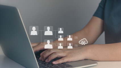 Person using laptop and network interface and glowing human resource for planning long-term, using...