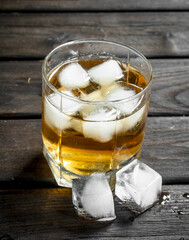 Whiskey in a glass with ice cubes.