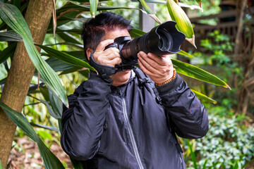 A photographer is using a SLR camera to create a shot