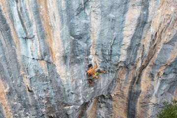 Strong man climbing a rock.