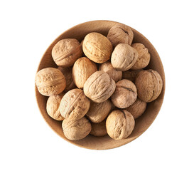 Walnuts in wooden bowl isolated on white background, top view.