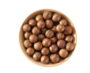 Macadamia in wooden bowl  isolated on white background, top view.