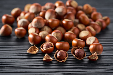hazelnut on a black kitchen table, selective focus.