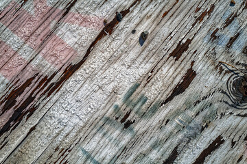Obraz premium Detail of a rotting wooden board with frost and faded lettering