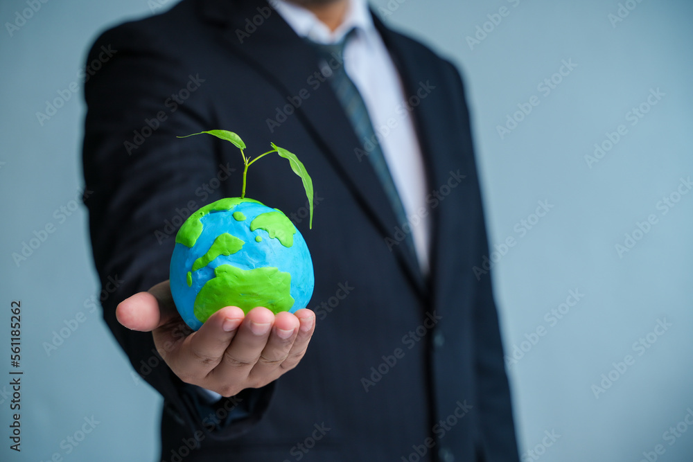 Wall mural Earth Day. ESG Concepts in Environment, Society and Governance green energy Renewable and Sustainable Resources Caring for the environment and ecology Business hand holding a green globe.