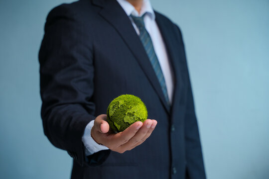 Earth Day. ESG Concepts in Environment, Society and Governance green energy Renewable and Sustainable Resources Caring for the environment and ecology Business hand holding a green globe.