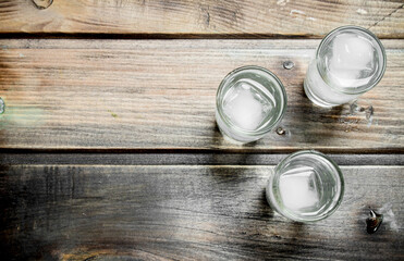 Vodka in a shot glass and ice cubes.