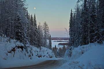 Winter road in the evening in the north of Russia.