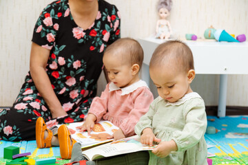 Grandmother and toddler reading books at home
