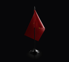 Small national flag of the Vietnam on a black background