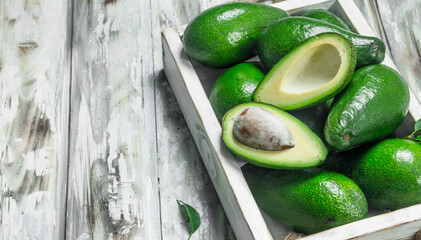 Avocado and avocado slices in white dressing.