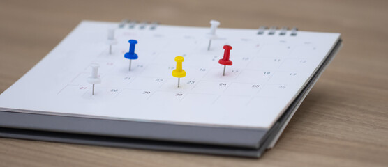 Closeup calendar page with drawing-pins , planning for business meeting or travel planning concept