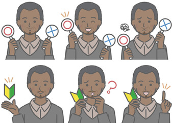 〇✕マークや初心者マークを持つ、中年の黒人男性