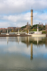 Public park with a large lake and communications tower in the city of Tres Cantos, Madrid, Spain.