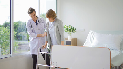 Portrait of caucasian doctor check up body of sick old senior elderly patient using walker, walking...