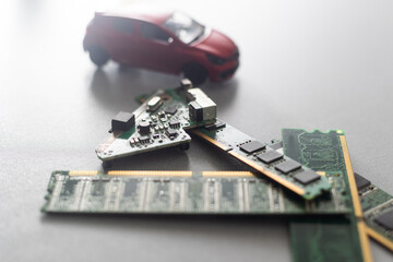 CPU chip and semiconductors with car toy. Global car chip shortage. Micro-chip shortage creates...