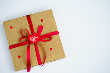 Wrapped vintage gift box with red ribbon bow, isolated on white