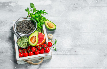 Healthy food. Different organic fruits and vegetables with black rice in wooden box.
