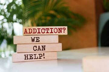 Wooden blocks with words 'Addiction? We can help!'. - obrazy, fototapety, plakaty