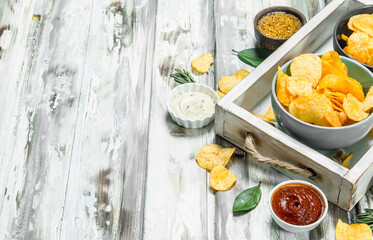 Potato chips with different sauces.