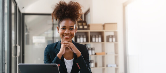 Young African American female working with tablet computer on remote project watching webinar. doing corporate data digital technology analysis.