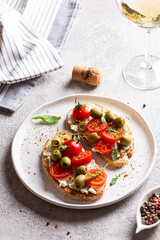 Appetizer with bruschetta with tomatoes and olives