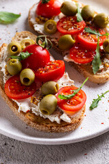 Appetizer with bruschetta with tomatoes and olives