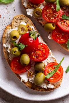 Appetizer with bruschetta with tomatoes and olives