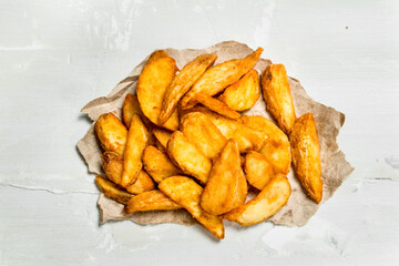 Baked potato slices on old paper.