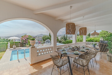 a garden terrace view from a chalet with swimming pool and Mediterranean scenery in the background 