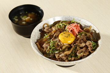 Gyudon bowl with beef, rice, onion, kimchi and egg