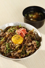 Gyudon bowl with beef, rice, onion, kimchi and egg