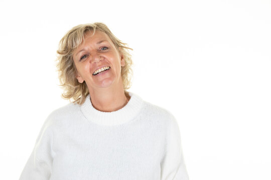 60 years blonde senior woman laughing mature with blue eyes blond on white background