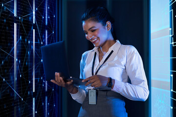 Female Technician/programmer working on the server in the data storage room